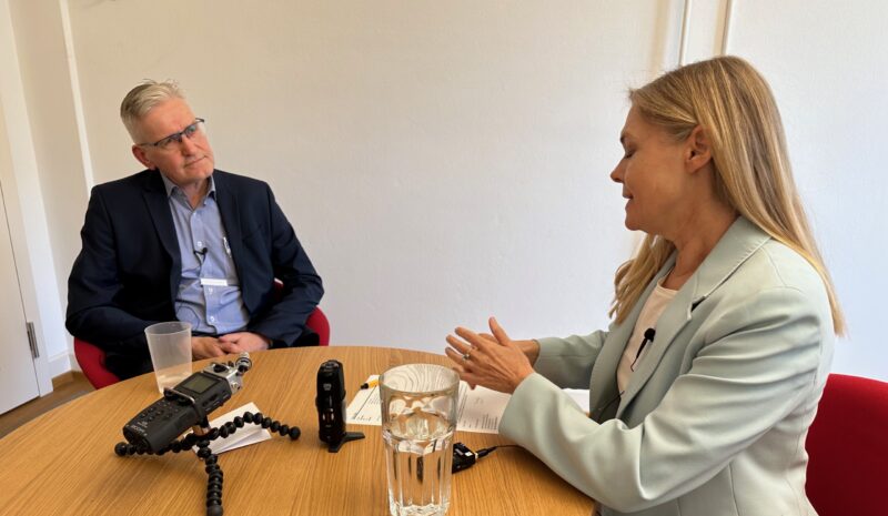 Zwei Personen sitzen am Tisch und sind im Gespräch